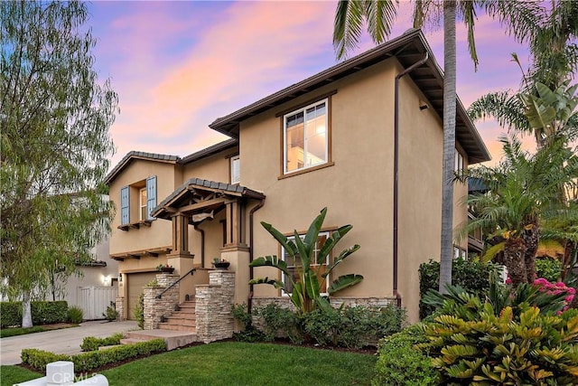 507 Corte Del Oro, San Clemente, CA 92673 - view of front of home with stucco siding, driveway, an attached garage, and a front lawn