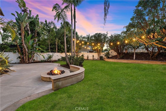 507 Corte Del Oro, San Clemente, CA 92673 - yard at dusk with a fire pit, a patio, a fenced backyard, and curved driveway