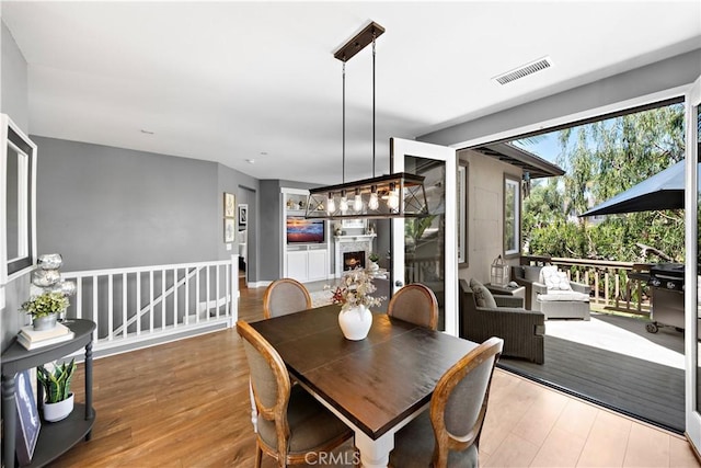 507 Corte Del Oro, San Clemente, CA 92673 - dining space with wood finished floors and a warm lit fireplace
