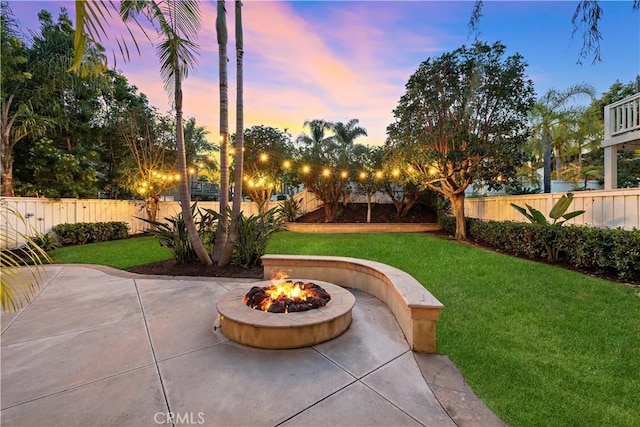 507 Corte Del Oro, San Clemente, CA 92673 - yard at dusk with an outdoor fire pit, a patio area, and a fenced backyard