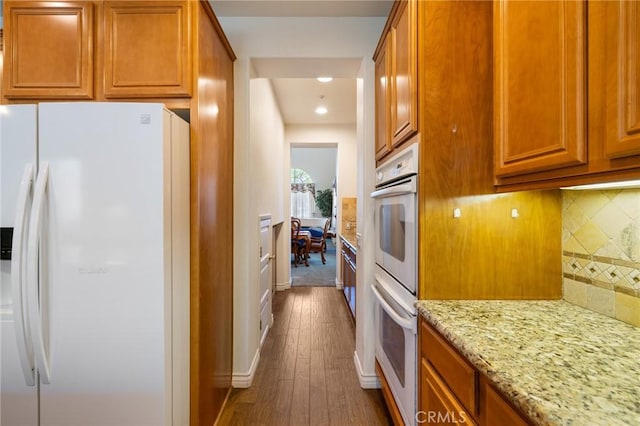 6411 Puma Pl, Rancho Cucamonga, CA 91737 - kitchen featuring white appliances, tasteful backsplash, dark wood-type flooring, light stone countertops, and recessed lighting