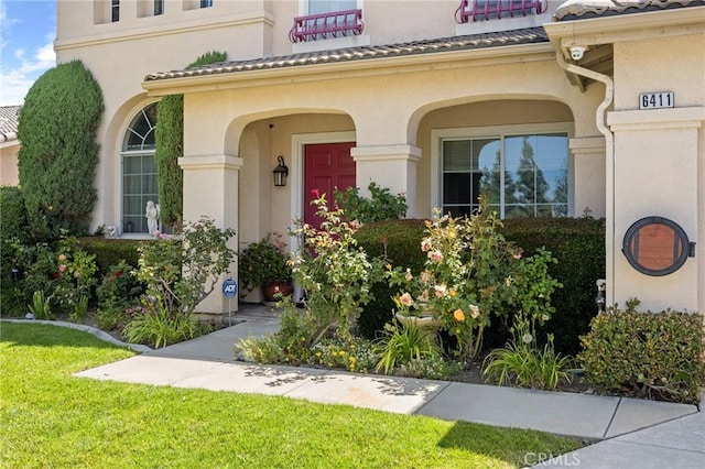 6411 Puma Pl, Rancho Cucamonga, CA 91737 - doorway to property with stucco siding, a tiled roof, and a yard