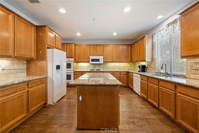 6411 Puma Pl, Rancho Cucamonga, CA 91737 - kitchen featuring white appliances, a center island, backsplash, dark wood-style flooring, and recessed lighting