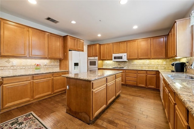 6411 Puma Pl, Rancho Cucamonga, CA 91737 - kitchen featuring white appliances, tasteful backsplash, a kitchen island, dark wood finished floors, and recessed lighting