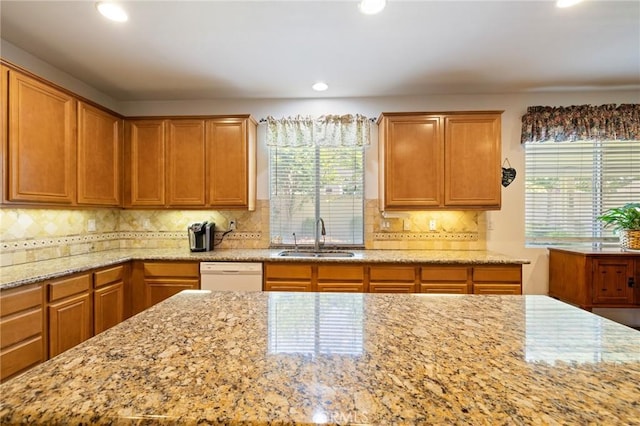 6411 Puma Pl, Rancho Cucamonga, CA 91737 - kitchen with white dishwasher, light stone countertops, recessed lighting, tasteful backsplash, and brown cabinetry