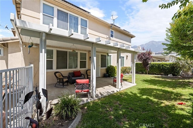 6411 Puma Pl, Rancho Cucamonga, CA 91737 - rear view of house featuring stucco siding, a lawn, a patio, and a mountain view