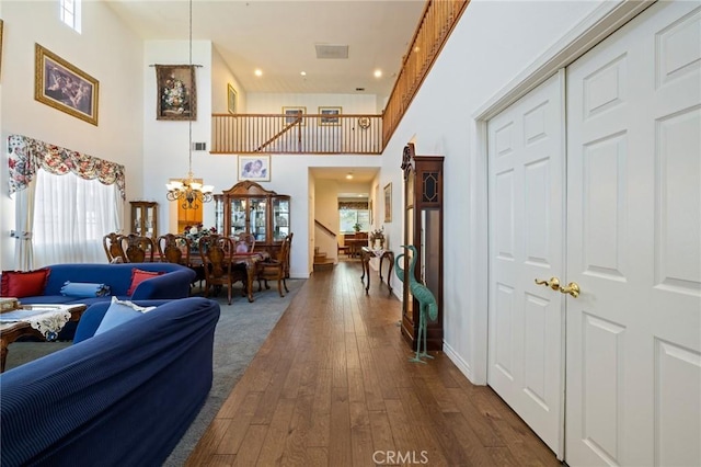 6411 Puma Pl, Rancho Cucamonga, CA 91737 - corridor featuring a chandelier, dark wood-type flooring, a high ceiling, recessed lighting, and stairway
