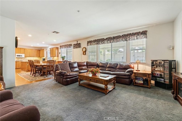 6411 Puma Pl, Rancho Cucamonga, CA 91737 - living area with plenty of natural light, light colored carpet, and recessed lighting