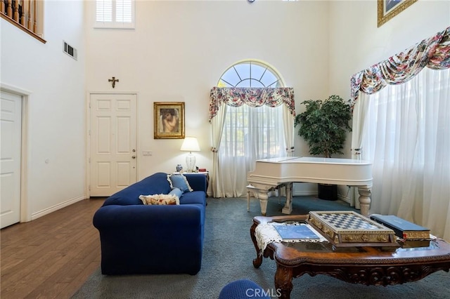 6411 Puma Pl, Rancho Cucamonga, CA 91737 - living room featuring a towering ceiling and wood finished floors