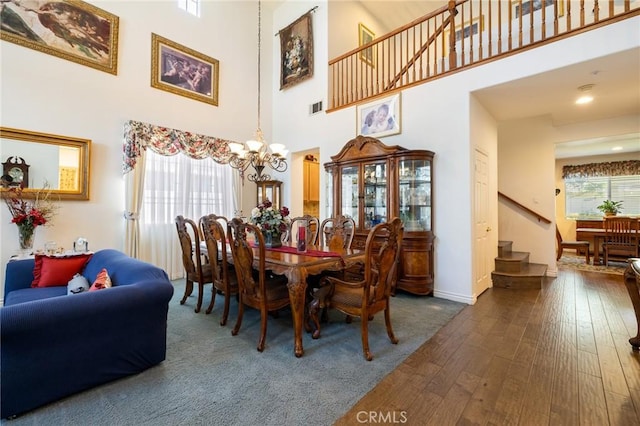 6411 Puma Pl, Rancho Cucamonga, CA 91737 - dining area with a chandelier, a high ceiling, dark wood finished floors, and stairway