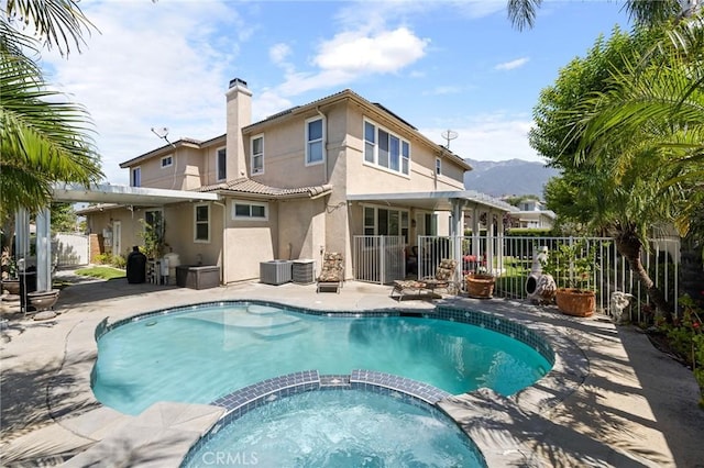 6411 Puma Pl, Rancho Cucamonga, CA 91737 - view of pool with a pool with connected hot tub, a patio area, and a mountain view