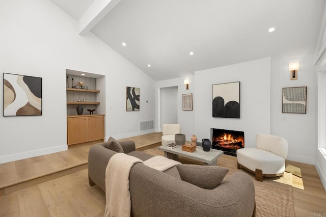 3835 Humboldt Dr, Huntington Beach, CA 92649 - living room with a lit fireplace, light wood-style floors, recessed lighting, beamed ceiling, and high vaulted ceiling