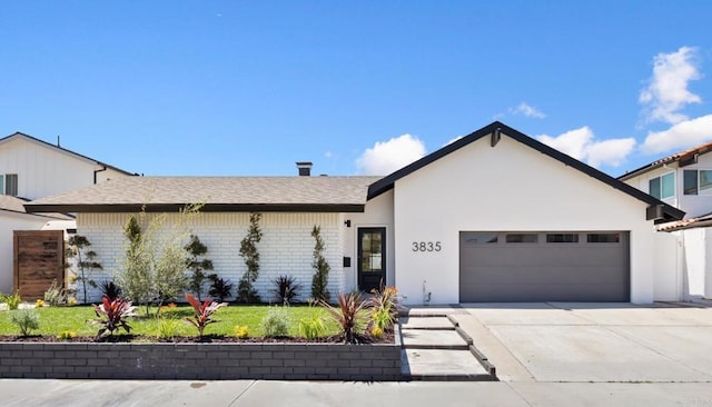 3835 Humboldt Dr, Huntington Beach, CA 92649 - view of front of home featuring an attached garage, driveway, and brick siding