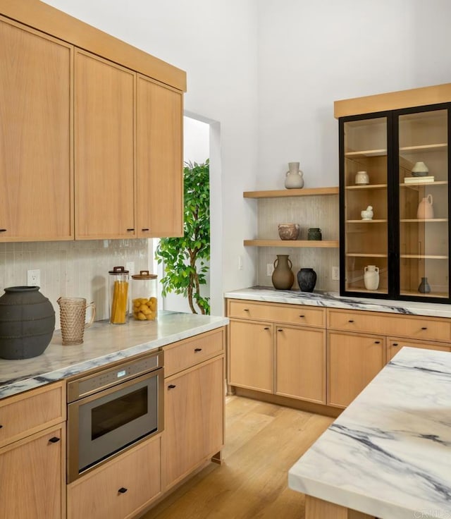 3835 Humboldt Dr, Huntington Beach, CA 92649 - kitchen with tasteful backsplash, light wood-style floors, light brown cabinetry, light stone countertops, and open shelves