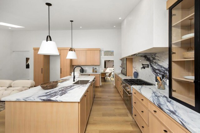 3835 Humboldt Dr, Huntington Beach, CA 92649 - kitchen featuring stainless steel stove, light brown cabinetry, light wood finished floors, decorative backsplash, and light stone counters