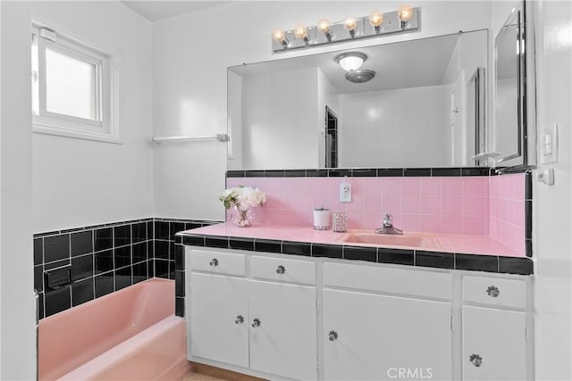 12319 Aneta St, Culver City, CA 90230 - bathroom featuring vanity, a garden tub, and decorative backsplash