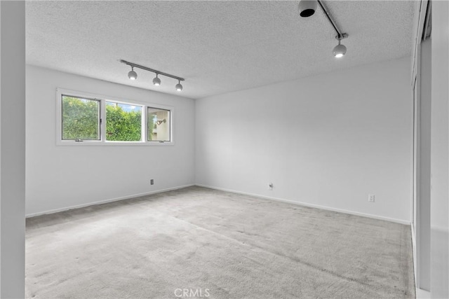 12319 Aneta St, Culver City, CA 90230 - spare room with track lighting, a textured ceiling, and carpet flooring