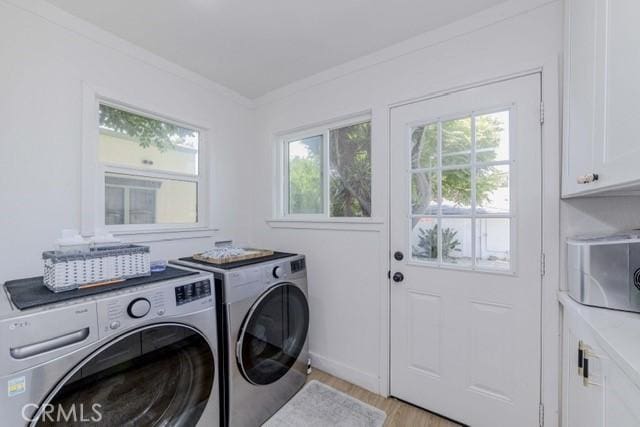 7933 Washington Ave, Whittier, CA 90602 - washroom with cabinet space, separate washer and dryer, healthy amount of natural light, crown molding, and light wood finished floors