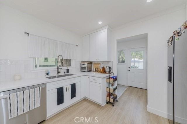 7933 Washington Ave, Whittier, CA 90602 - kitchen with dishwashing machine, decorative backsplash, white cabinets, and recessed lighting