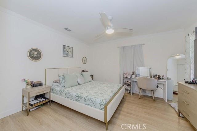 7933 Washington Ave, Whittier, CA 90602 - bedroom with light wood-style floors, a ceiling fan, an office area, and ornamental molding