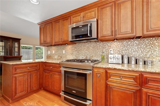 39 Foxhill, Irvine, CA 92604 - kitchen with appliances with stainless steel finishes and brown cabinetry