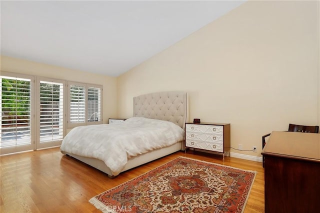 39 Foxhill, Irvine, CA 92604 - bedroom with lofted ceiling, access to exterior, and wood finished floors