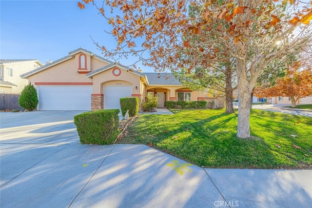 2104 W W Ave J6, Lancaster, CA 93536 - view of front facade featuring stucco siding, concrete driveway, a garage, and stone siding