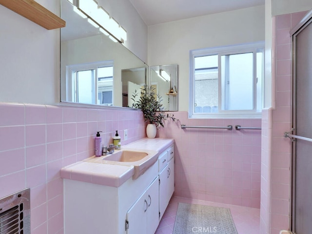 3042 E 3rd St Unit 5, Long Beach, CA 90814 - bathroom featuring tile walls, healthy amount of natural light, vanity, a shower with door, and tile patterned floors