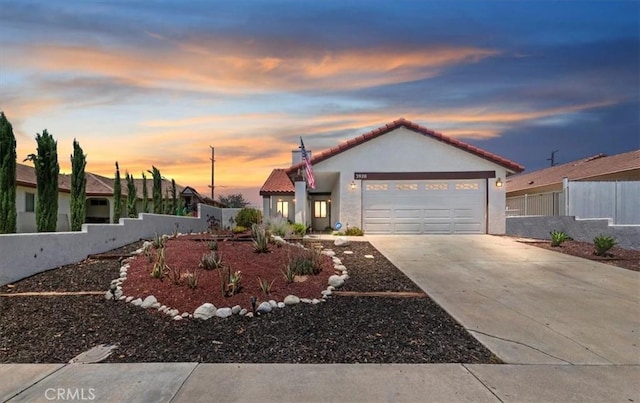 3920 Roxbury Dr, Hemet, CA 92545 - mediterranean / spanish-style house with an attached garage, concrete driveway, a tile roof, and stucco siding