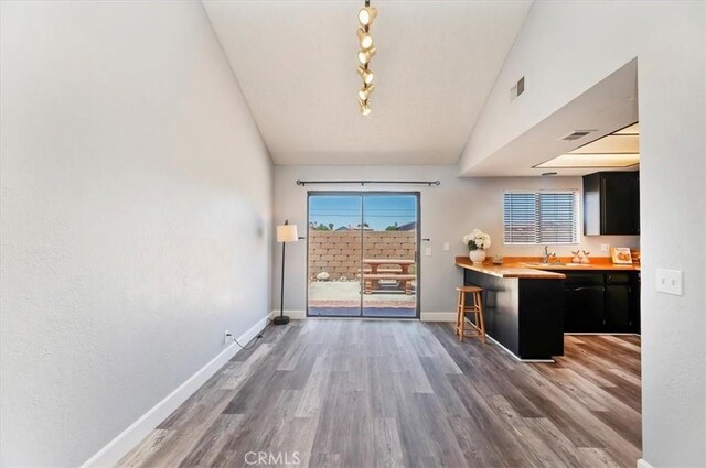 3920 Roxbury Dr, Hemet, CA 92545 - unfurnished dining area featuring wood finished floors and vaulted ceiling