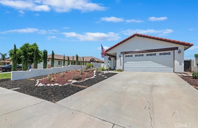 3920 Roxbury Dr, Hemet, CA 92545 - view of front facade with concrete driveway, stucco siding, a tiled roof, and a garage