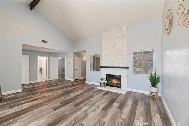 3920 Roxbury Dr, Hemet, CA 92545 - unfurnished living room with high vaulted ceiling, wood finished floors, beam ceiling, and a fireplace