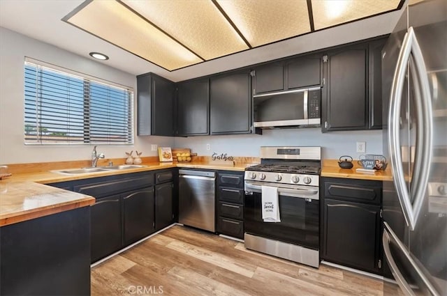 3920 Roxbury Dr, Hemet, CA 92545 - kitchen with appliances with stainless steel finishes, light wood finished floors, and dark cabinets