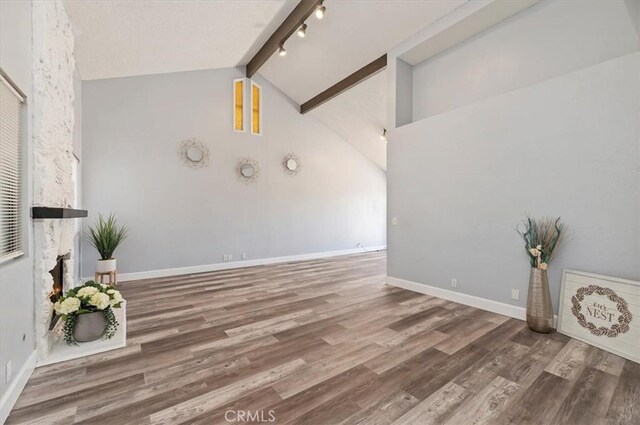 3920 Roxbury Dr, Hemet, CA 92545 - unfurnished living room featuring beamed ceiling, wood finished floors, track lighting, and high vaulted ceiling