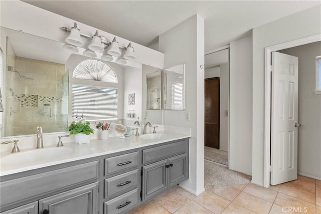 20241 Edmund Rd, Riverside, CA 92508 - bathroom featuring tile patterned flooring, tiled shower, double vanity, and healthy amount of natural light