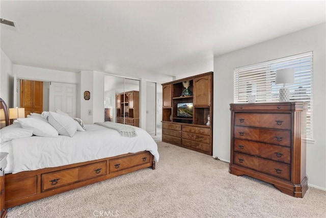 20241 Edmund Rd, Riverside, CA 92508 - bedroom featuring light carpet and two closets