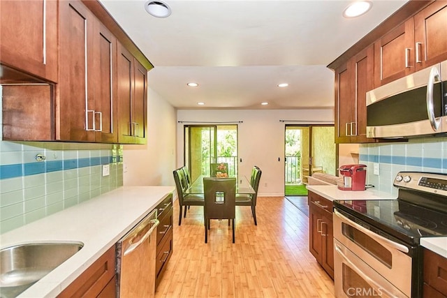 535 W Duarte Rd Unit 14, Arcadia, CA 91007 - kitchen with stainless steel appliances, backsplash, recessed lighting, light countertops, and light wood-style floors