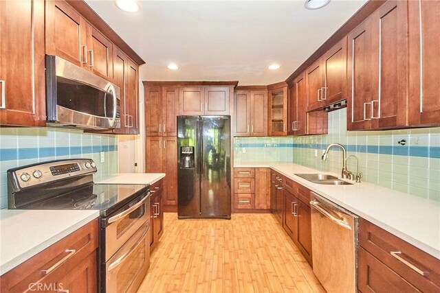 535 W Duarte Rd Unit 14, Arcadia, CA 91007 - kitchen with stainless steel appliances, light wood finished floors, backsplash, recessed lighting, and light countertops
