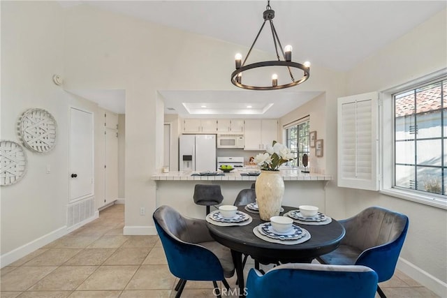 43791 Calle Las Brisas W, Palm Desert, CA 92211 - dining space featuring a chandelier, light tile patterned floors, a raised ceiling, and lofted ceiling