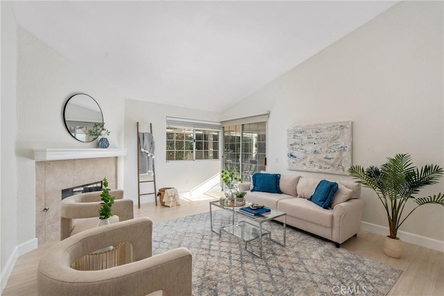 43791 Calle Las Brisas W, Palm Desert, CA 92211 - living area with wood finished floors, vaulted ceiling, and a fireplace