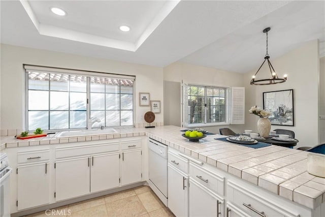 43791 Calle Las Brisas W, Palm Desert, CA 92211 - kitchen with white dishwasher, a peninsula, a chandelier, recessed lighting, and white cabinetry