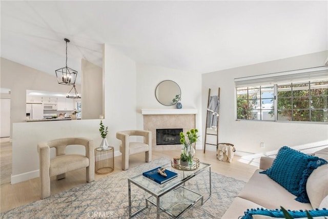 43791 Calle Las Brisas W, Palm Desert, CA 92211 - living room featuring wood finished floors, a fireplace, and a chandelier