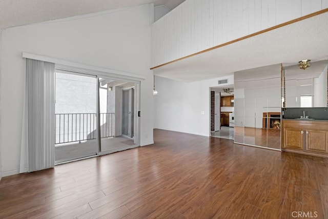 20155 Keswick St Unit 211, Winnetka, CA 91306 - unfurnished living room featuring dark wood finished floors and high vaulted ceiling