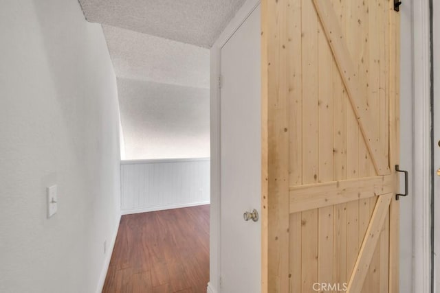 20155 Keswick St Unit 211, Winnetka, CA 91306 - corridor with wood finished floors, a textured ceiling, and wooden walls