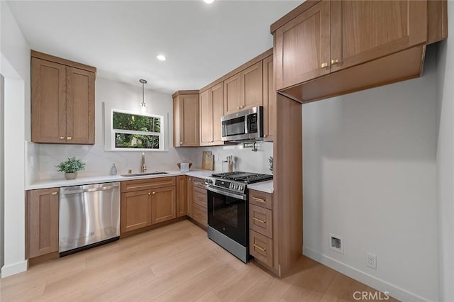 1951 Wagner St, Pasadena, CA 91107 - kitchen with appliances with stainless steel finishes, light wood-style floors, tasteful backsplash, light countertops, and recessed lighting