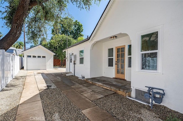 1951 Wagner St, Pasadena, CA 91107 - view of property exterior with stucco siding, a detached garage, an outbuilding, and concrete driveway