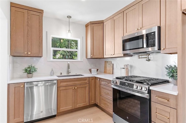 1951 Wagner St, Pasadena, CA 91107 - kitchen with stainless steel appliances, light countertops, light wood-style floors, and backsplash
