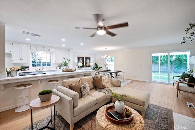6330 N Wilson Ave, Fresno, CA 93704 - living room with light wood-style flooring, a ceiling fan, plenty of natural light, a chandelier, and recessed lighting