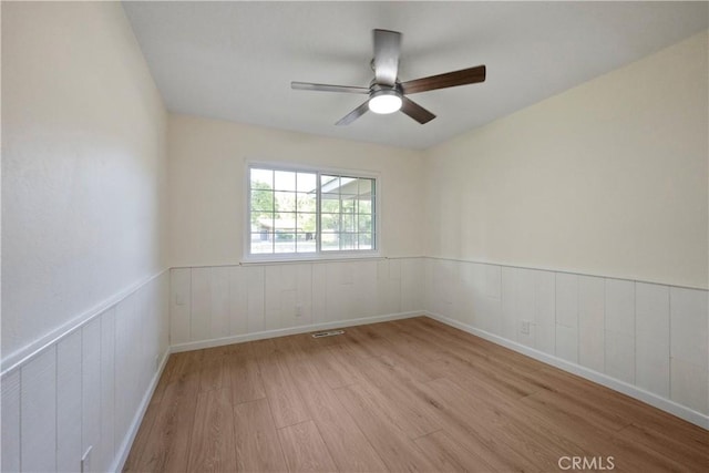6330 N Wilson Ave, Fresno, CA 93704 - spare room with wood finished floors, wainscoting, and ceiling fan