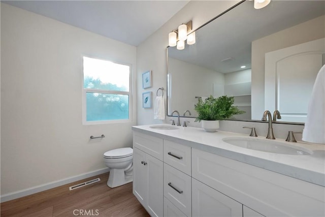 6330 N Wilson Ave, Fresno, CA 93704 - bathroom featuring double vanity and wood finished floors